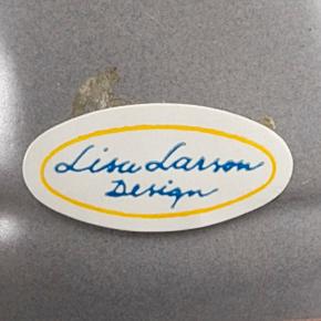 LISA LARSON, a set of three candle sticks.