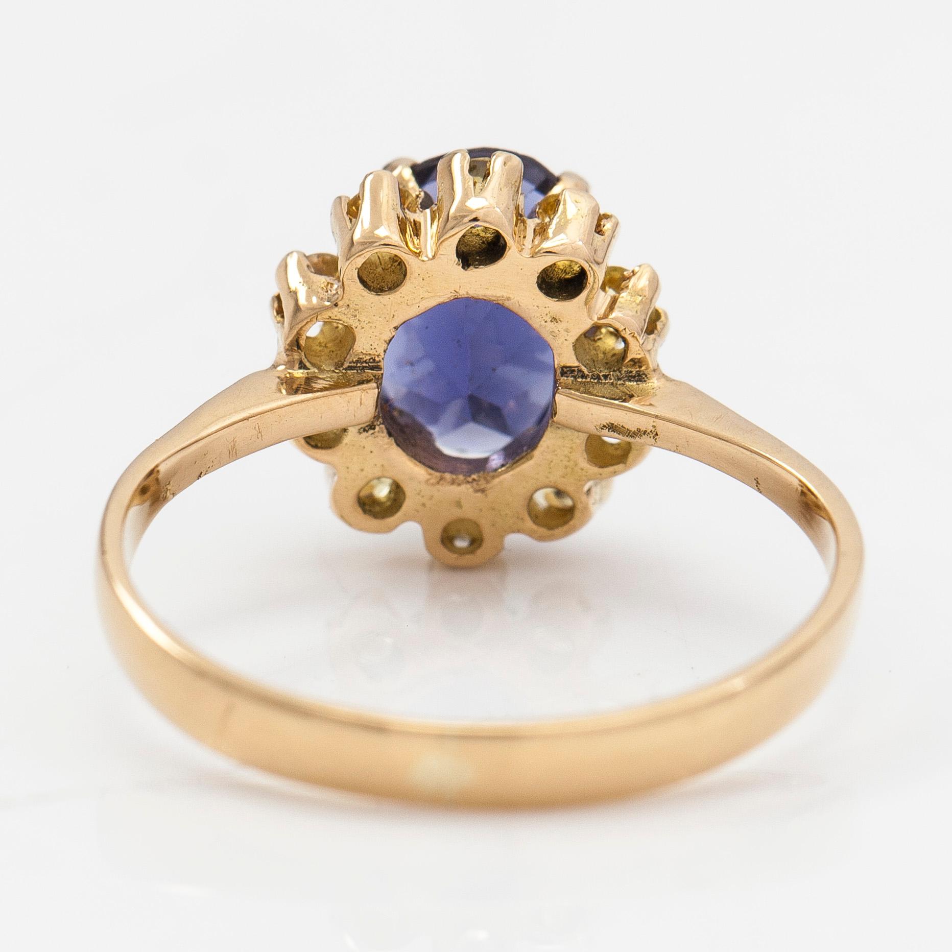 An 18K gold ring with a tanzanite and yellow sapphires.