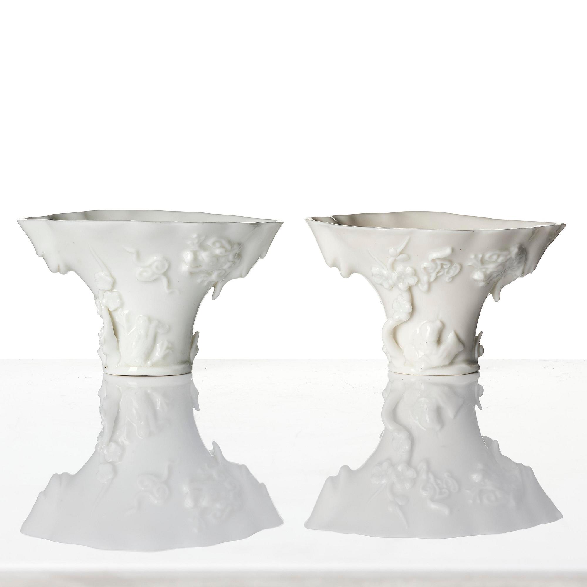 A pair of blanc de chine rhinoceros libation cups, Qing dynasty, Kangxi (1662-1722).