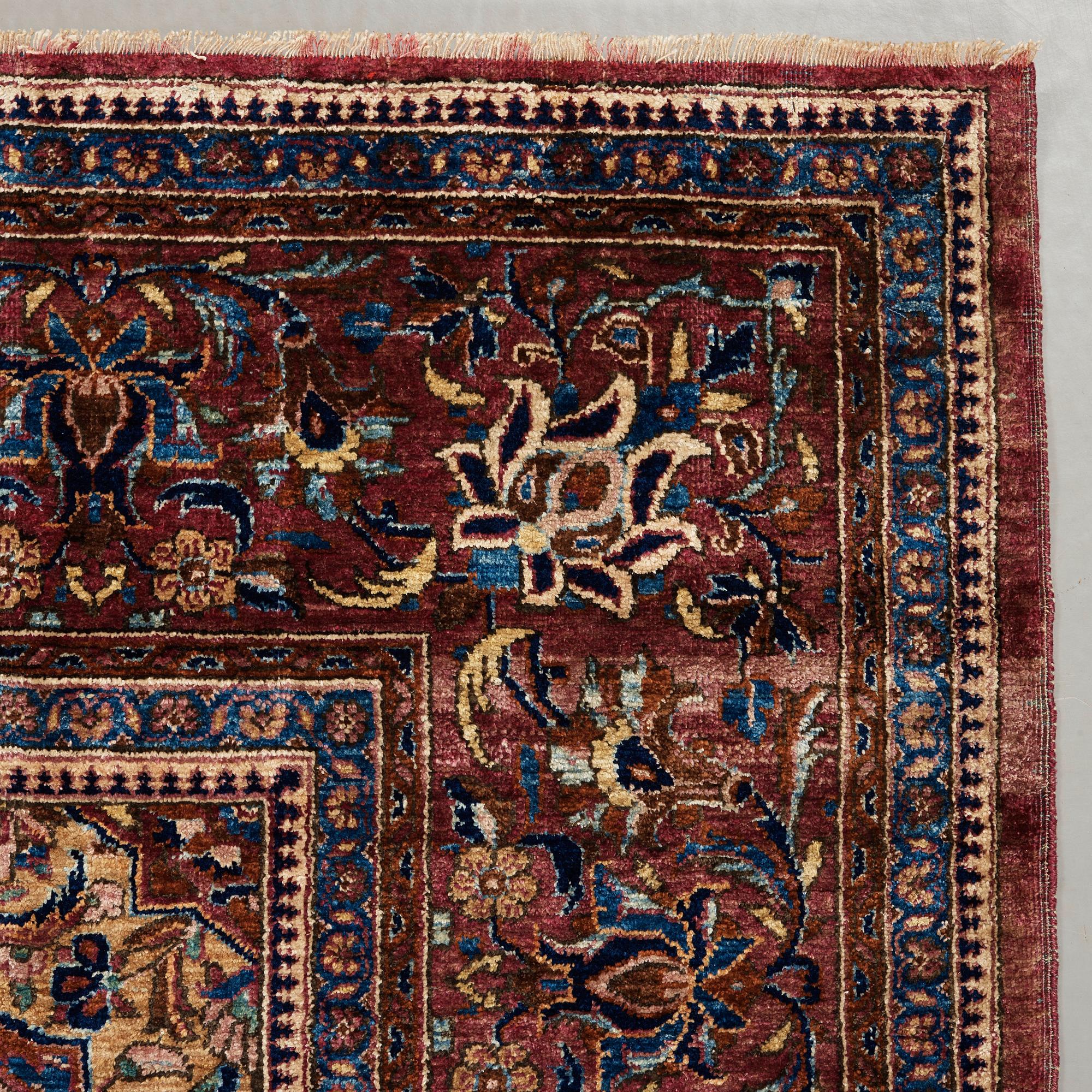 A RUG. A semi-antique silk Kashan. 205,5 x 131,5 cm.