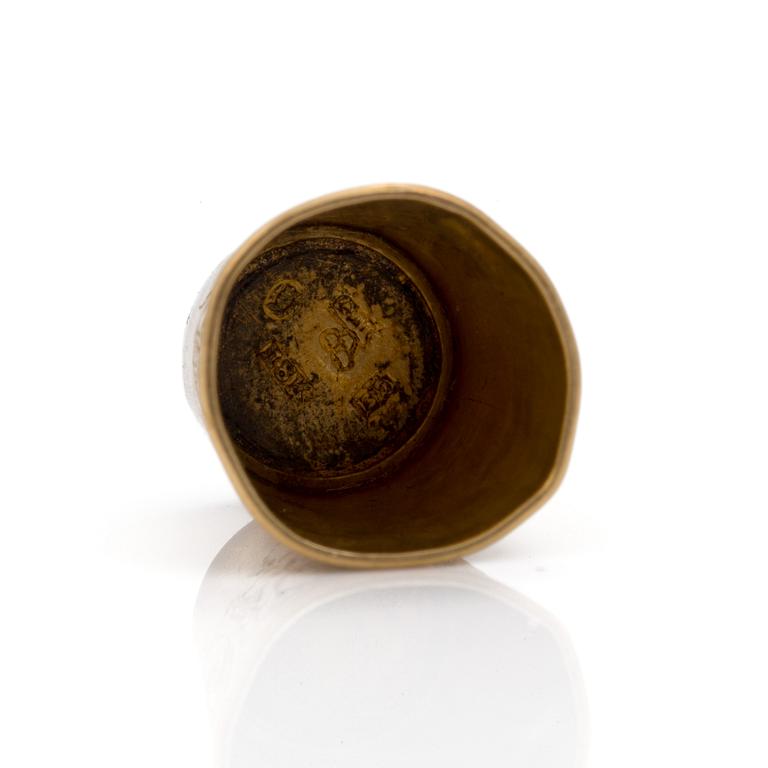 An 18K gold thimble.