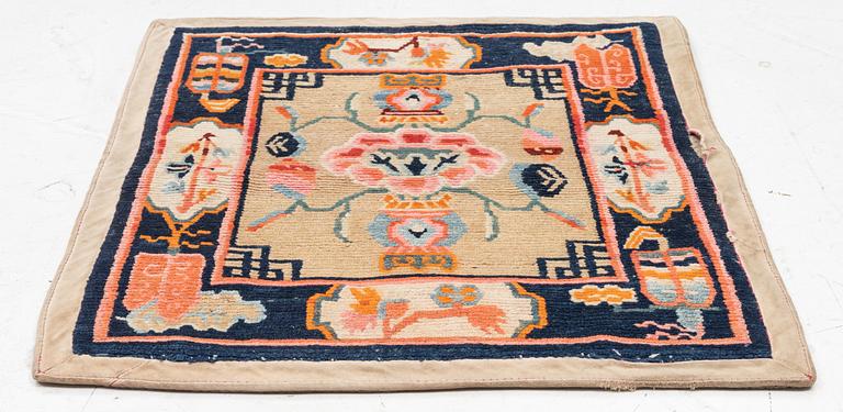 An antique Tibetian meditation rug, approximately 70 x 60 cm.