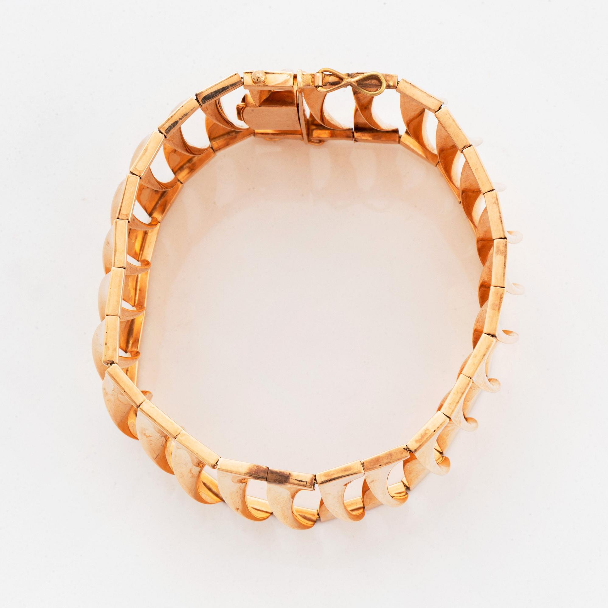 A 14K gold bracelet and a brooch.