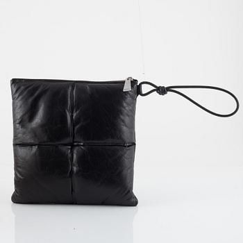 Bottega Veneta, a black leather handbag.