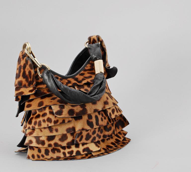 A leopard patterned pony skin handbag by Yves Saint Laurent.