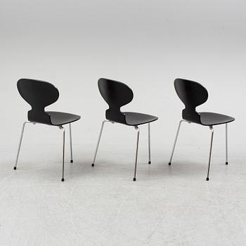 An Arne Jacobsen "Centenary Package" comprising three "Ant Chairs" and an eggshaped table, Fritz Hansen, Denmark.