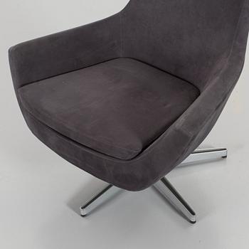 A SWEDESE SWIVEL ARMCHAIR.