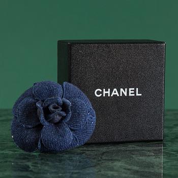 A Camelia brooch by Chanel.