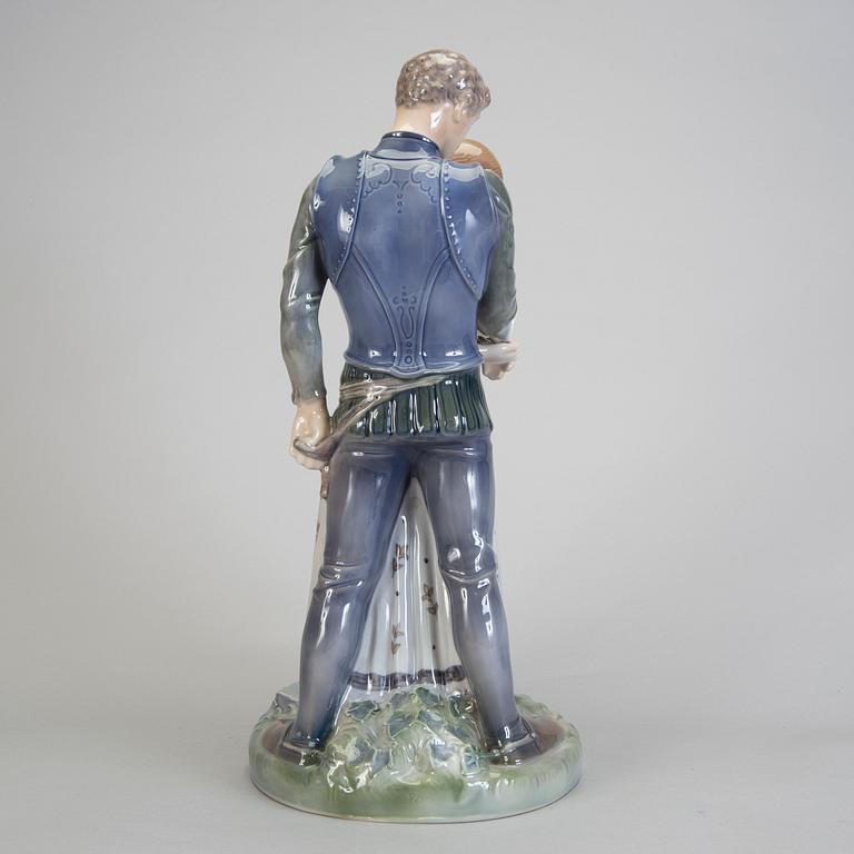 A porcelain figurine of a boy and girl model 3171 Royal Copenhagen.