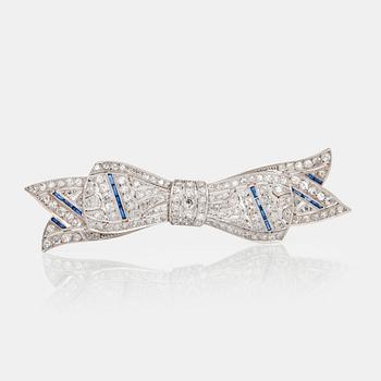 501. A circa 1920's bow brooch set with sapphires and old-cut diamonds.