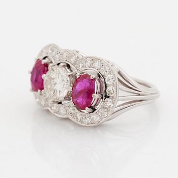 An 18K white gold ring set with faceted rubies and a round brilliant-cut diamond and eight-cut diamonds.