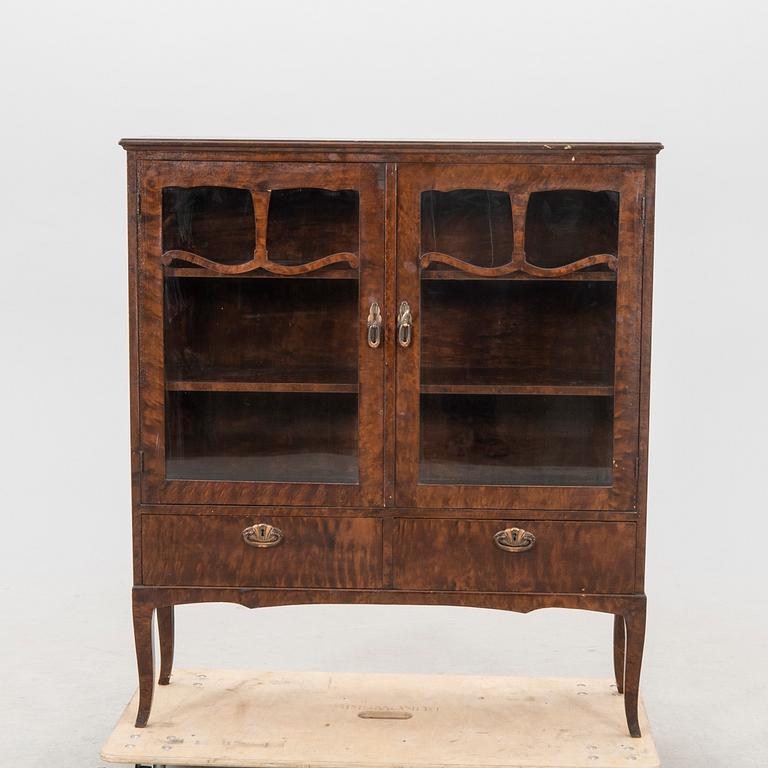 A 1920s  stained beech display cabinet.