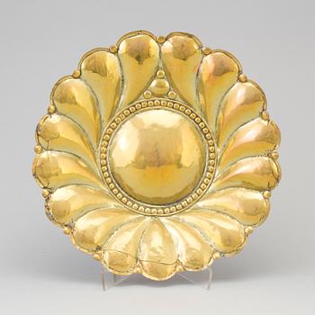 A 17th century brass wall plaque.