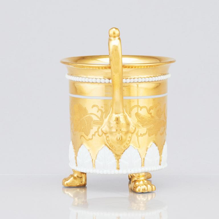 A gilded French Empire cup with stand, 19th Century.