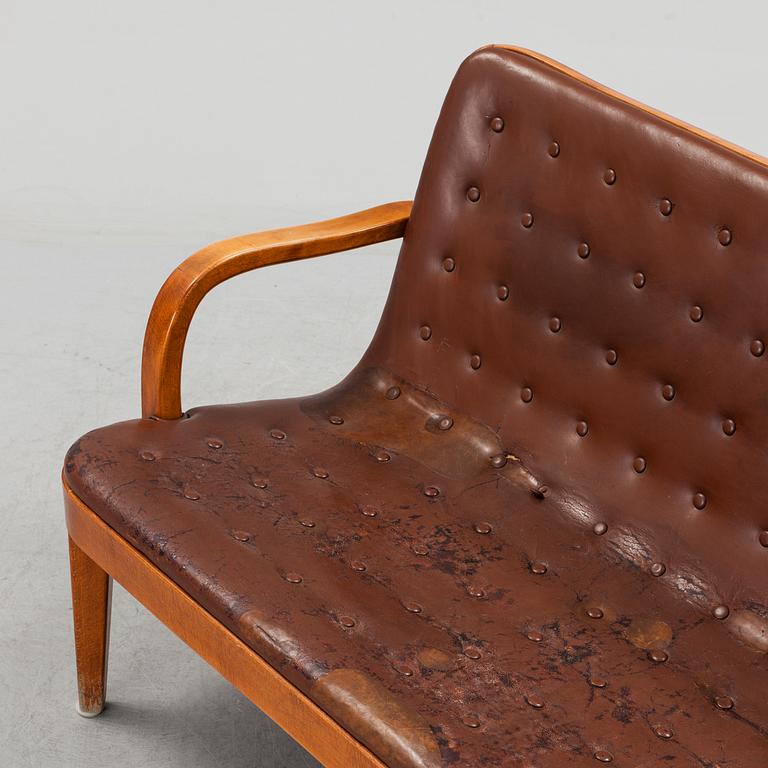 An Axel Larsson stained beech leather upholstered sofa, Svenska Möbelfabrikerna Bodafors, 1930's.