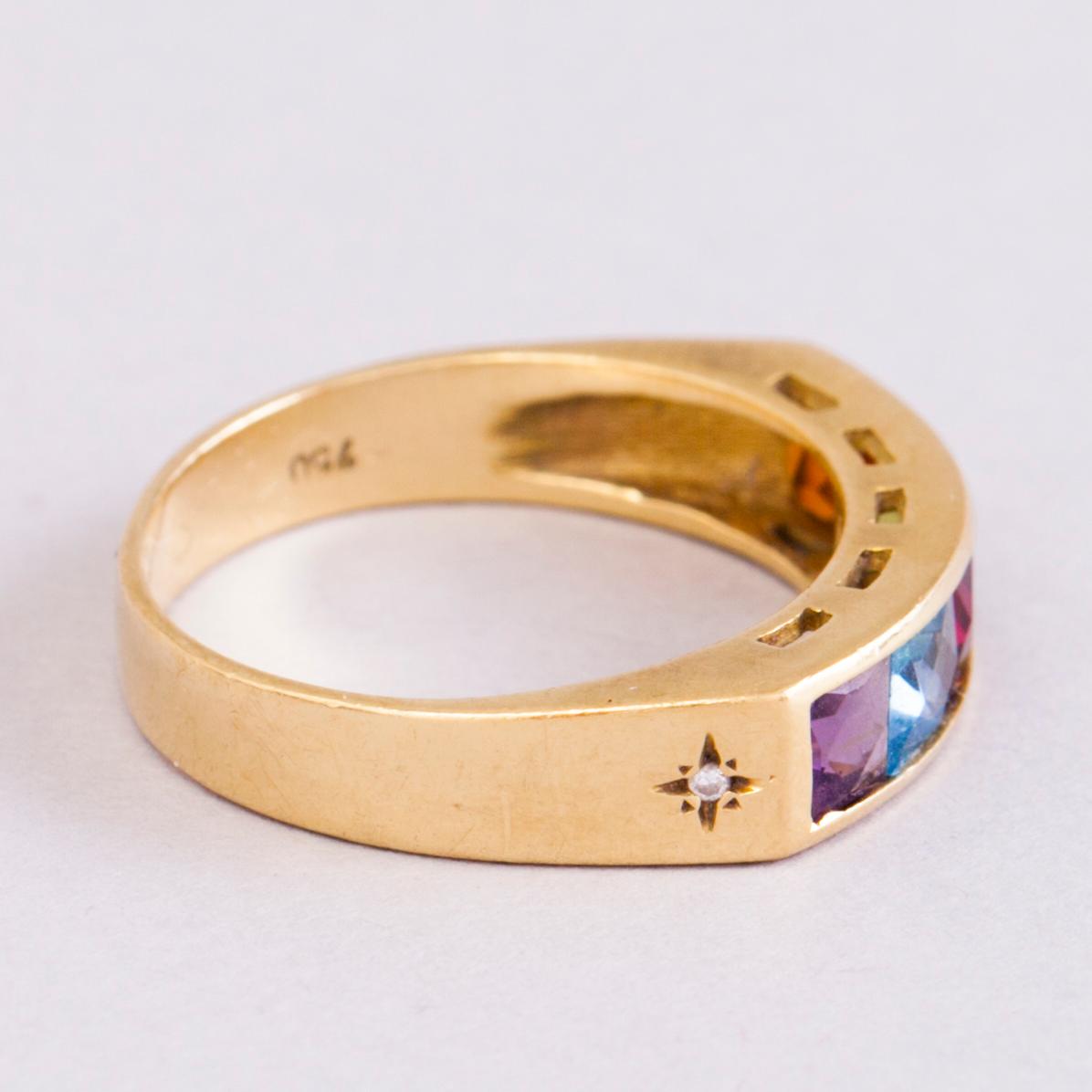 A 18K gold ring with 5 different stones: citrine, amethyst, topaz, garnet, peridot and a small diamond. Probably H.Stern.