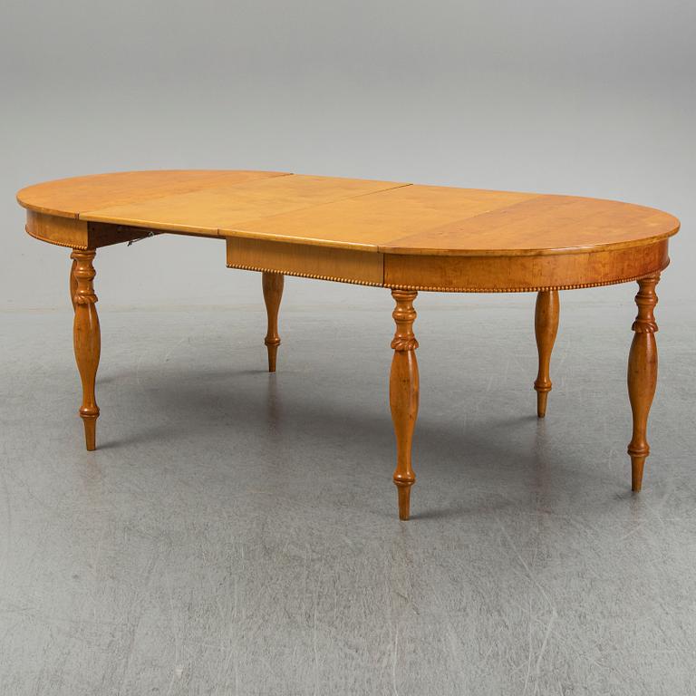 A mid 19th century birch dining table.