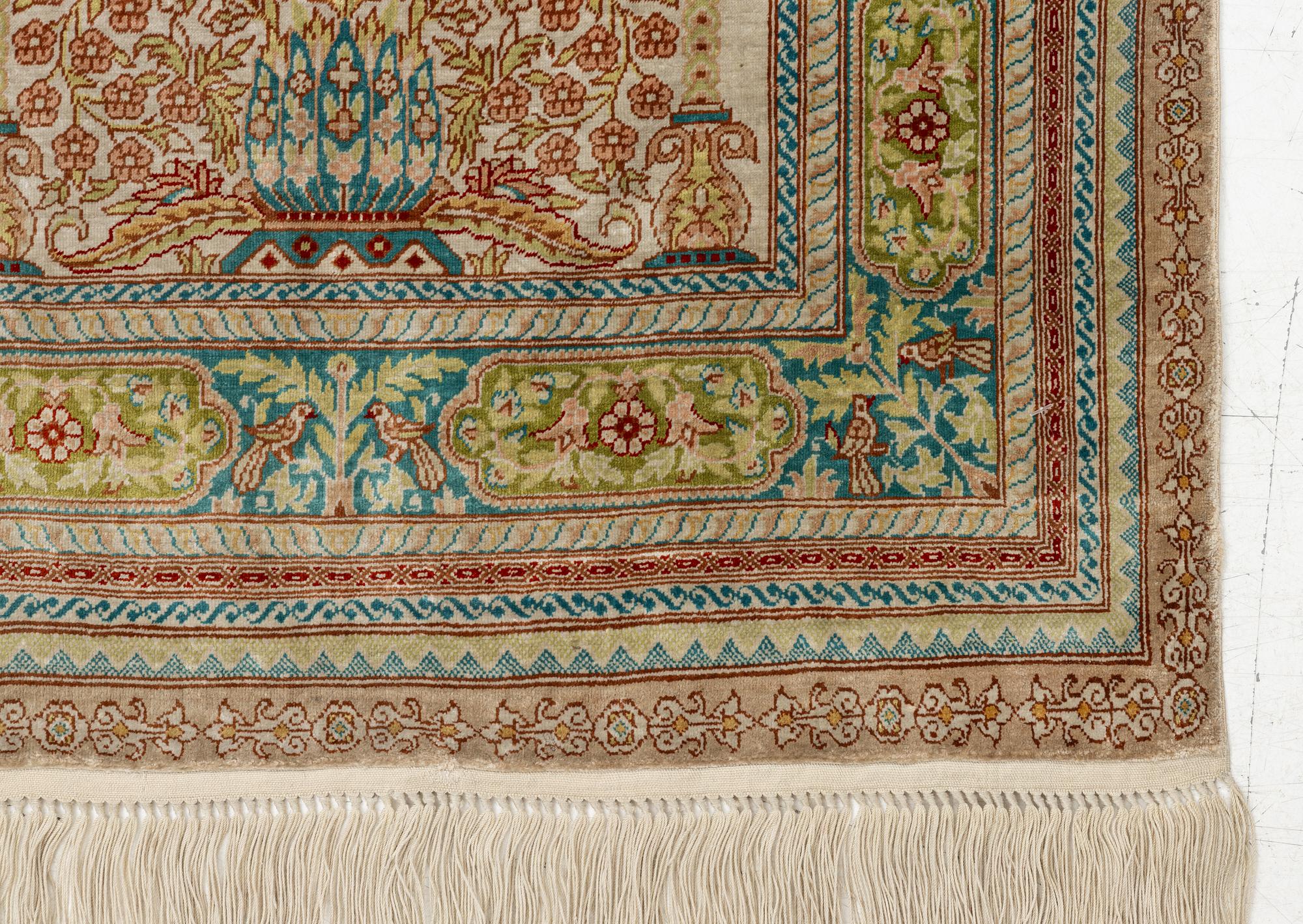A semi-antique silk Hereke, c. 92 x 61 cm.