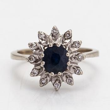An 18K whitegold ring with diamonds totalling approx 0.06 ct and a sapphire. With Swedish import mark.