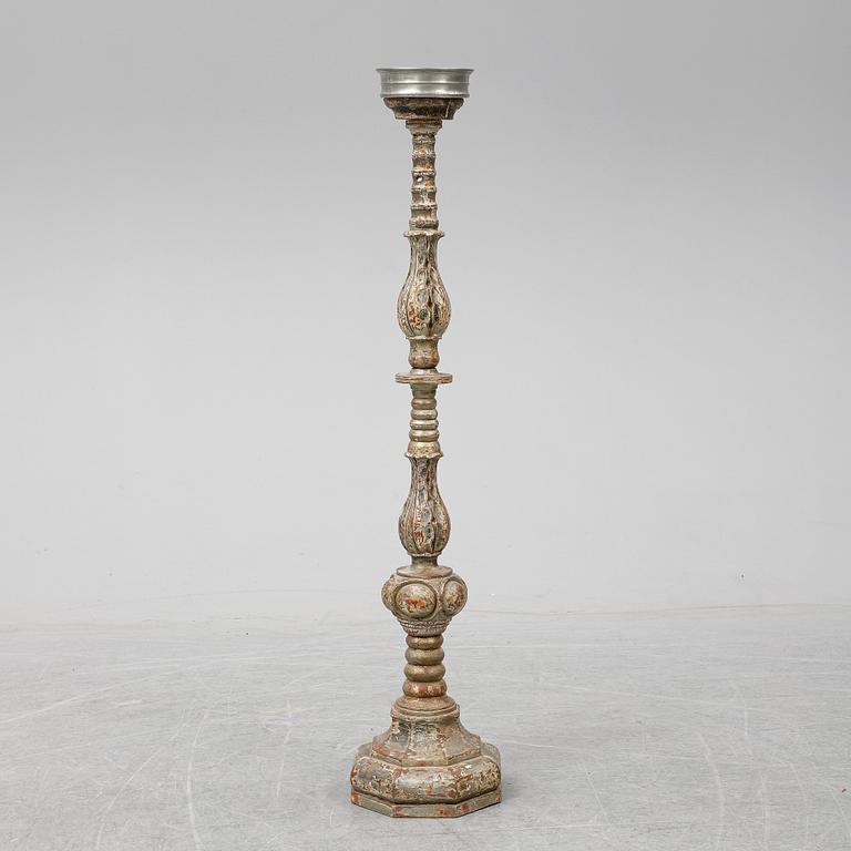 A wooden altar candlestick.