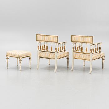 A pair of late Gustavian-style open armchairs and a stool, circa 1900.