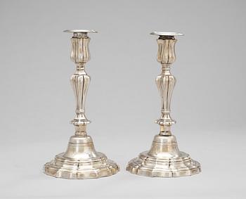 A pair of French 18th century silvered brass candlesticks.