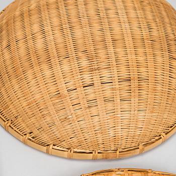 A mid-20th century rattan basket and two rattan trays. Retailer Artek Finland.