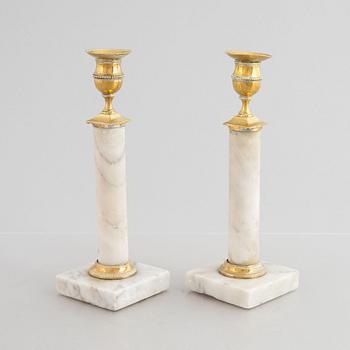 A pair of Gustavian gilt brass and marble candlesticks, late 18th century.