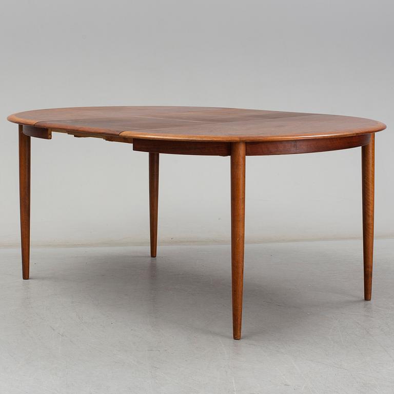 KURT ØSTERVIG, a teak dining suite with a round table and six chairs, Brande Möbelindustri, Denmark.