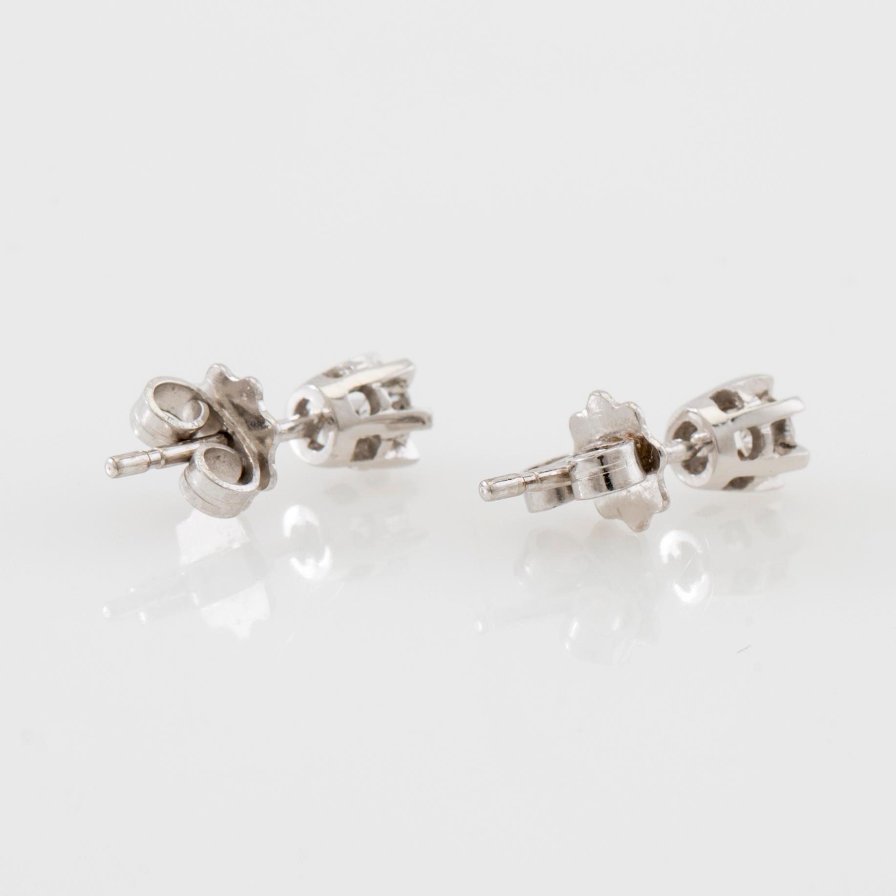 Earrings, a pair of 18K white gold set with round brilliant-cut diamonds.