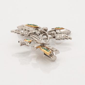 Platinum and gold with brilliant cut diamonds and emerald brooch.