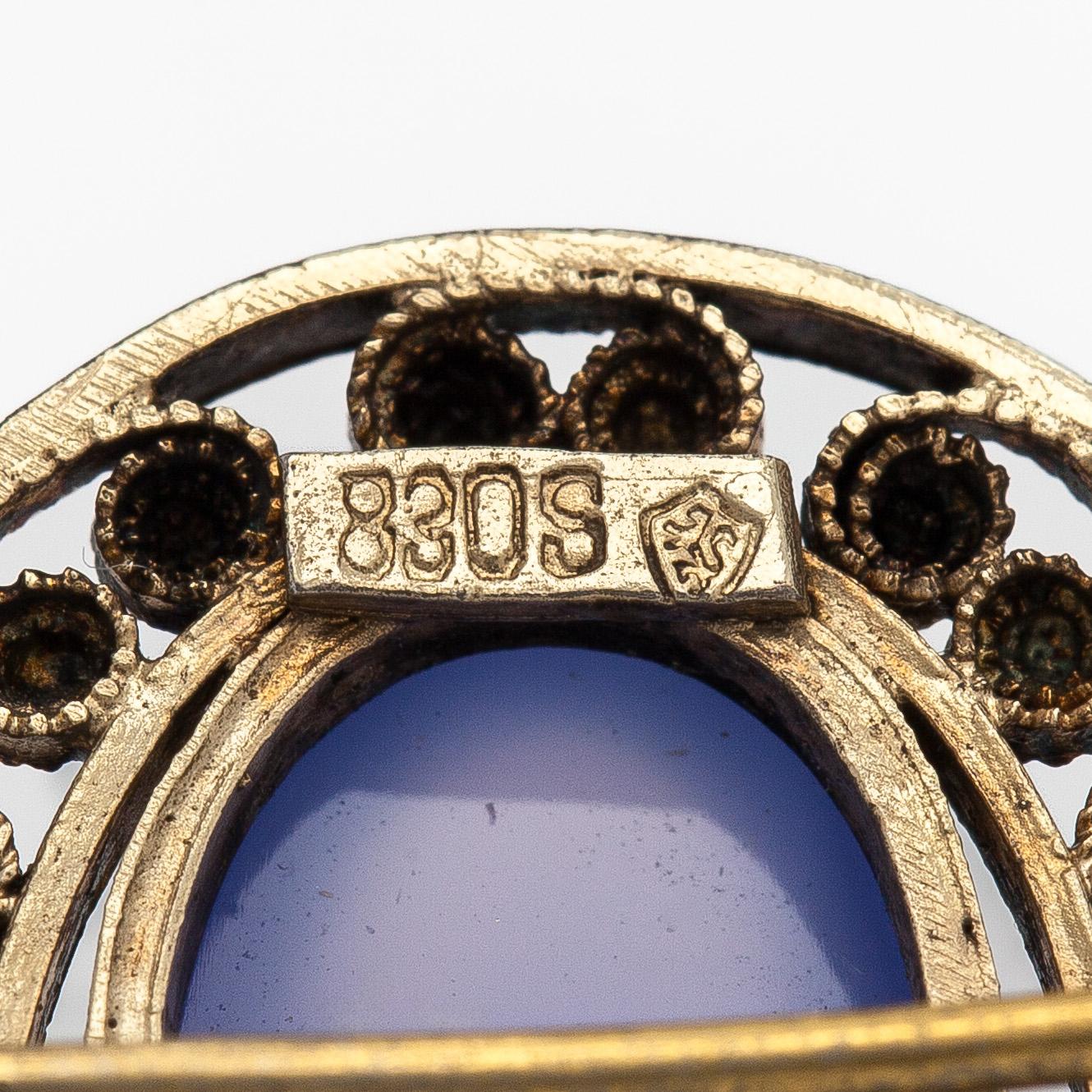 Brooch, cabochon-cut moonstones, gilded silver.