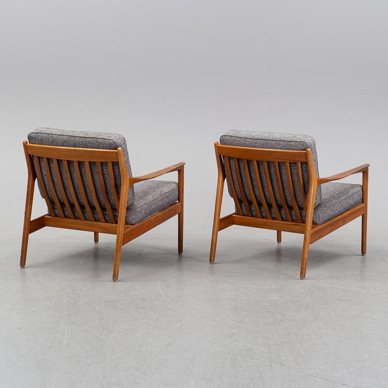 A pair of USA 75, teak lounge chairs by Folke Ohlsson for Dux.