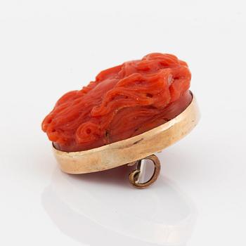 A 14K gold and coral cameo brooch.