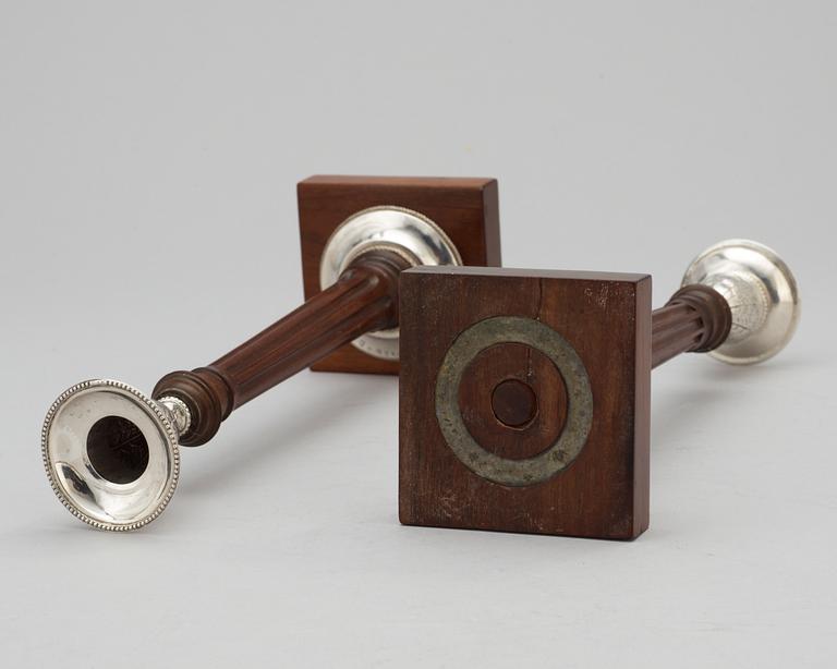 A pair of Swedish silver and mahogany candlesticks by Peter Ohlijn, Karlskrona 1800.