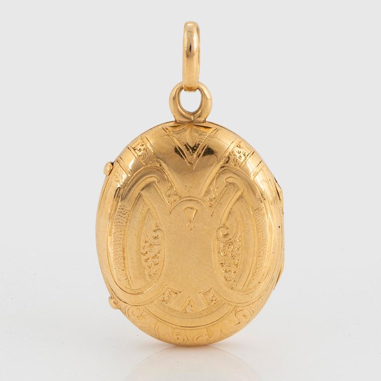 An 18K gold Möllenborg locket with black enamel decoration.