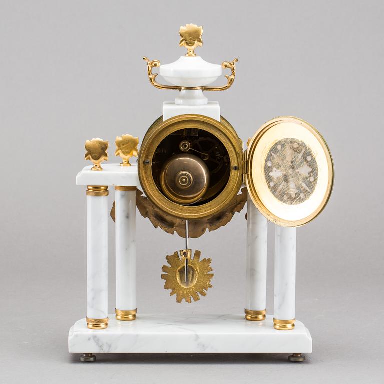 A Louis XVI-style mantle clock.