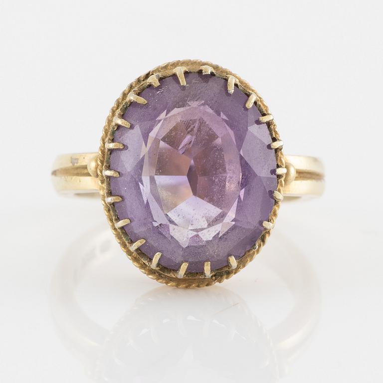 A set with a necklace, a bracelet, a brooch, and a ring.