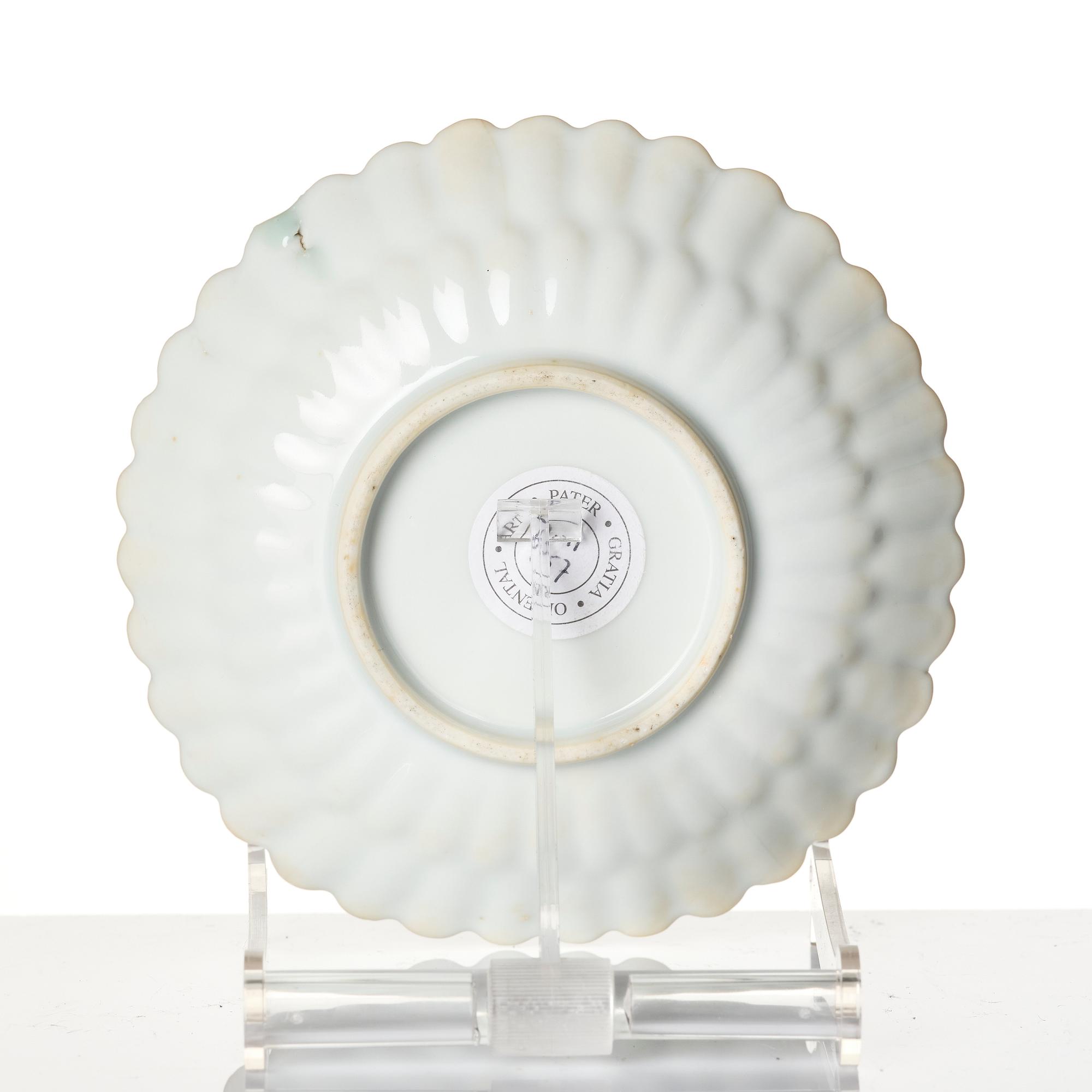 A Chinese iron red porcelain cup with saucer and a small famille verte dish, Qing dynasty, Kangxi (1662-1722).