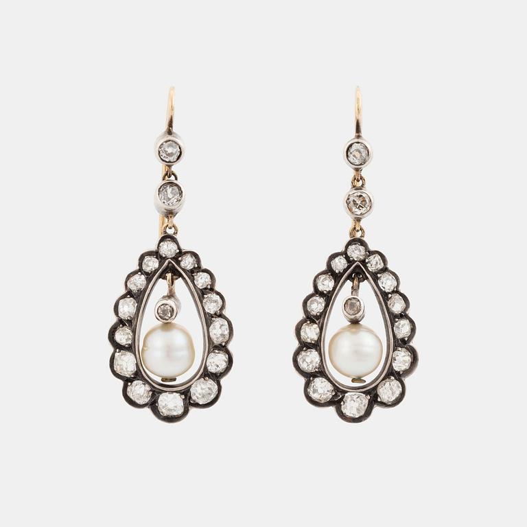A pair of silver and gold earrings set with old-cut diamonds and pearls.