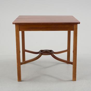 A mid 20th century mahogany veneered table from Nordiska Kompaniet (NK).