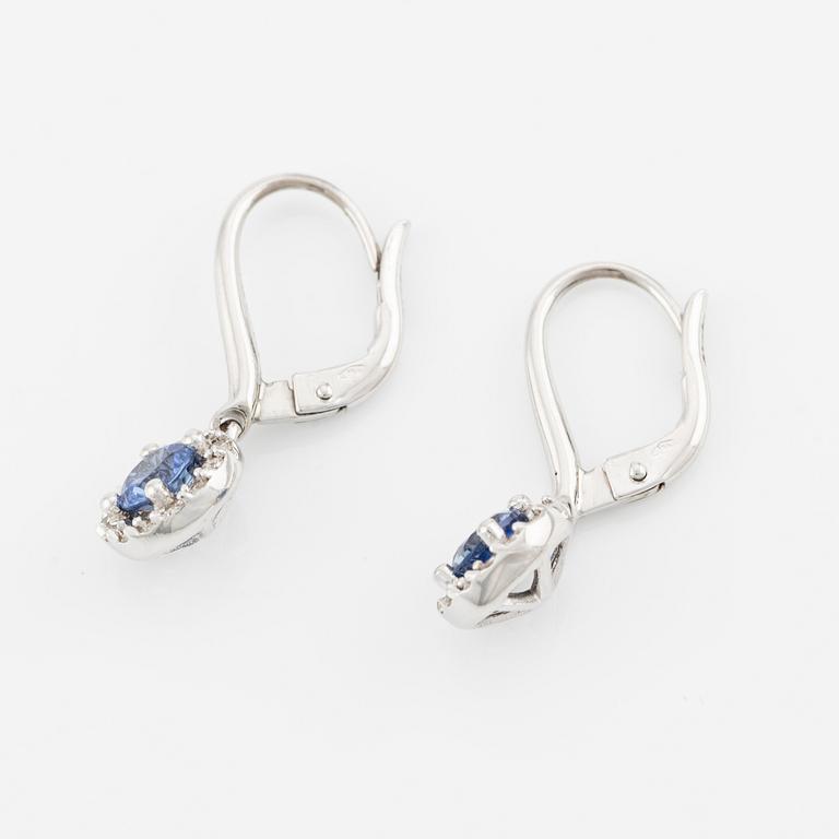 A pair of 18K gold earrings with faceted sapphires and round brilliant-cut diamonds.