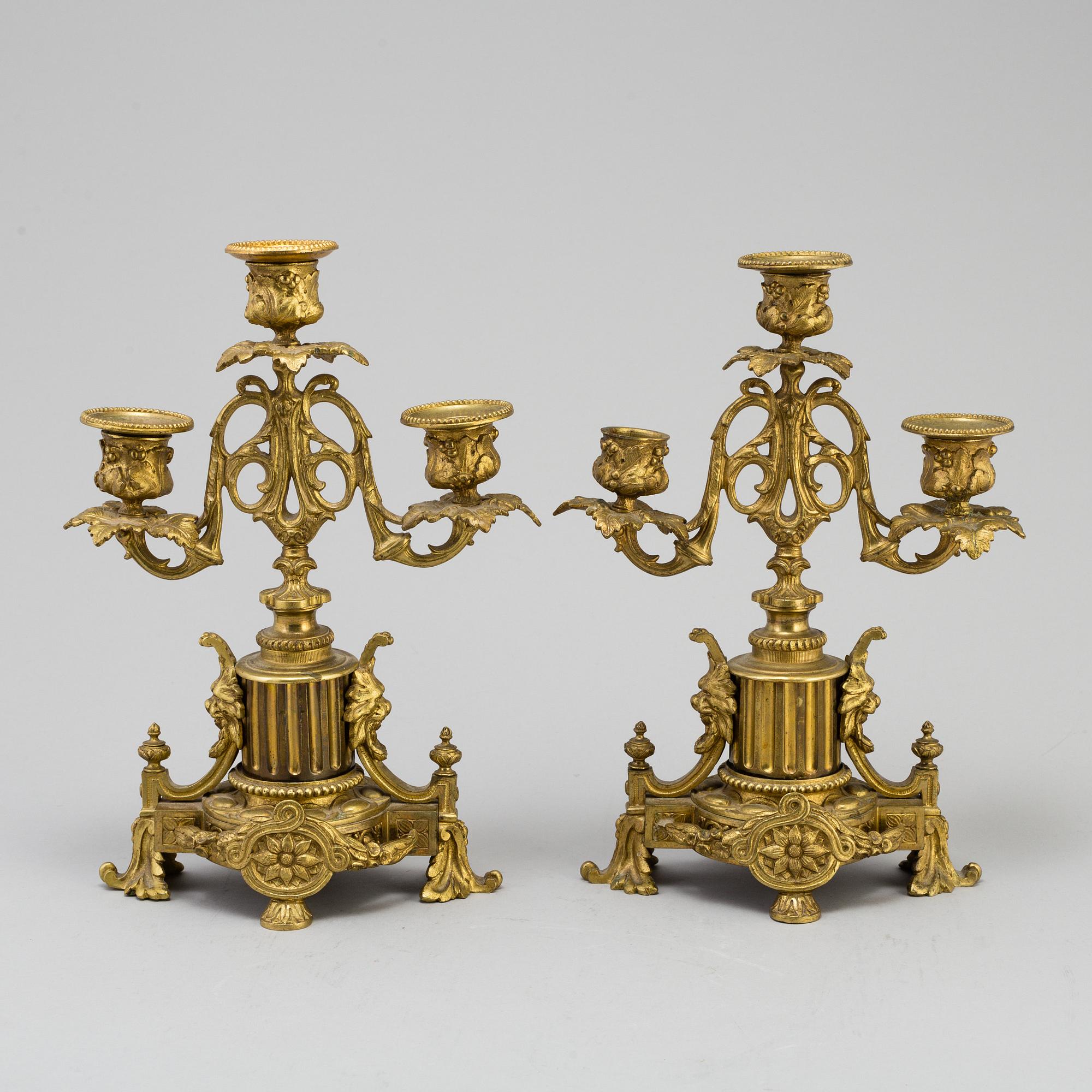 A table CLOCK and a pair of candelabra, second part of 19th century.