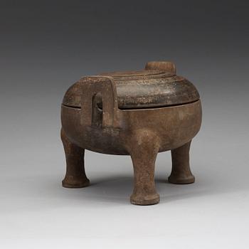 A pottery tripod censer, Han dynasty (206 B.C. -220 A.D.).