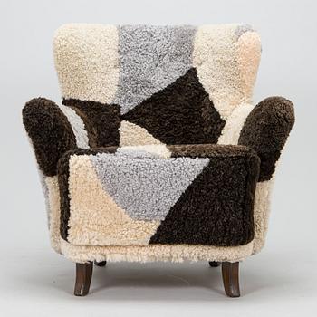 A 1950s lamb skin armchair.