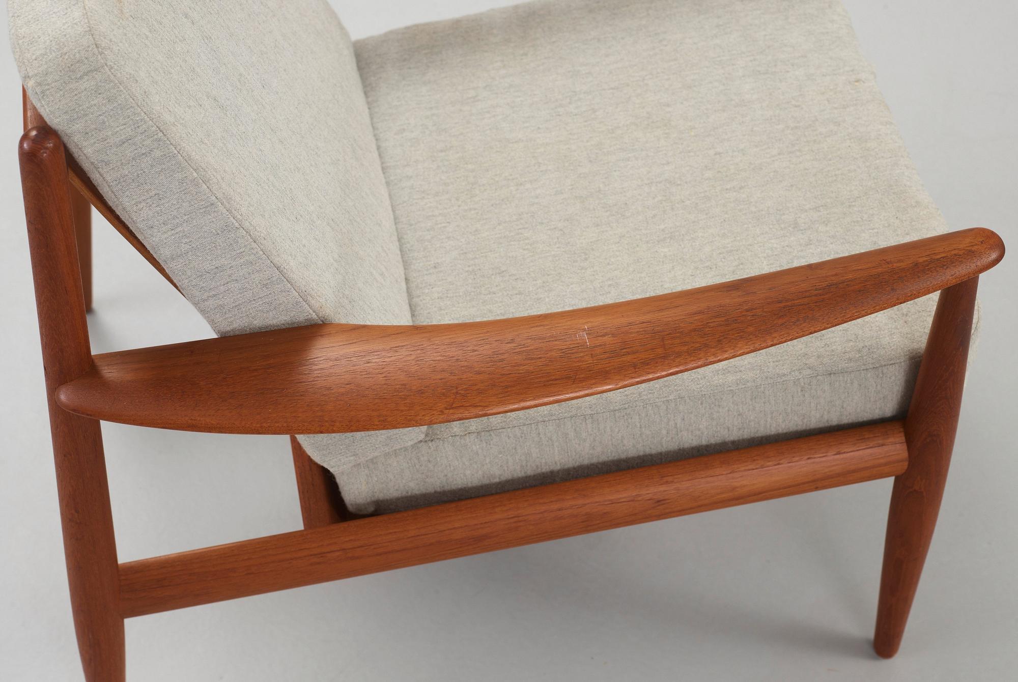 A Grete Jalk teak sofa and armchair, cusions upholstered in grey fabric, France & Daverkosen, Denmark 1960's.