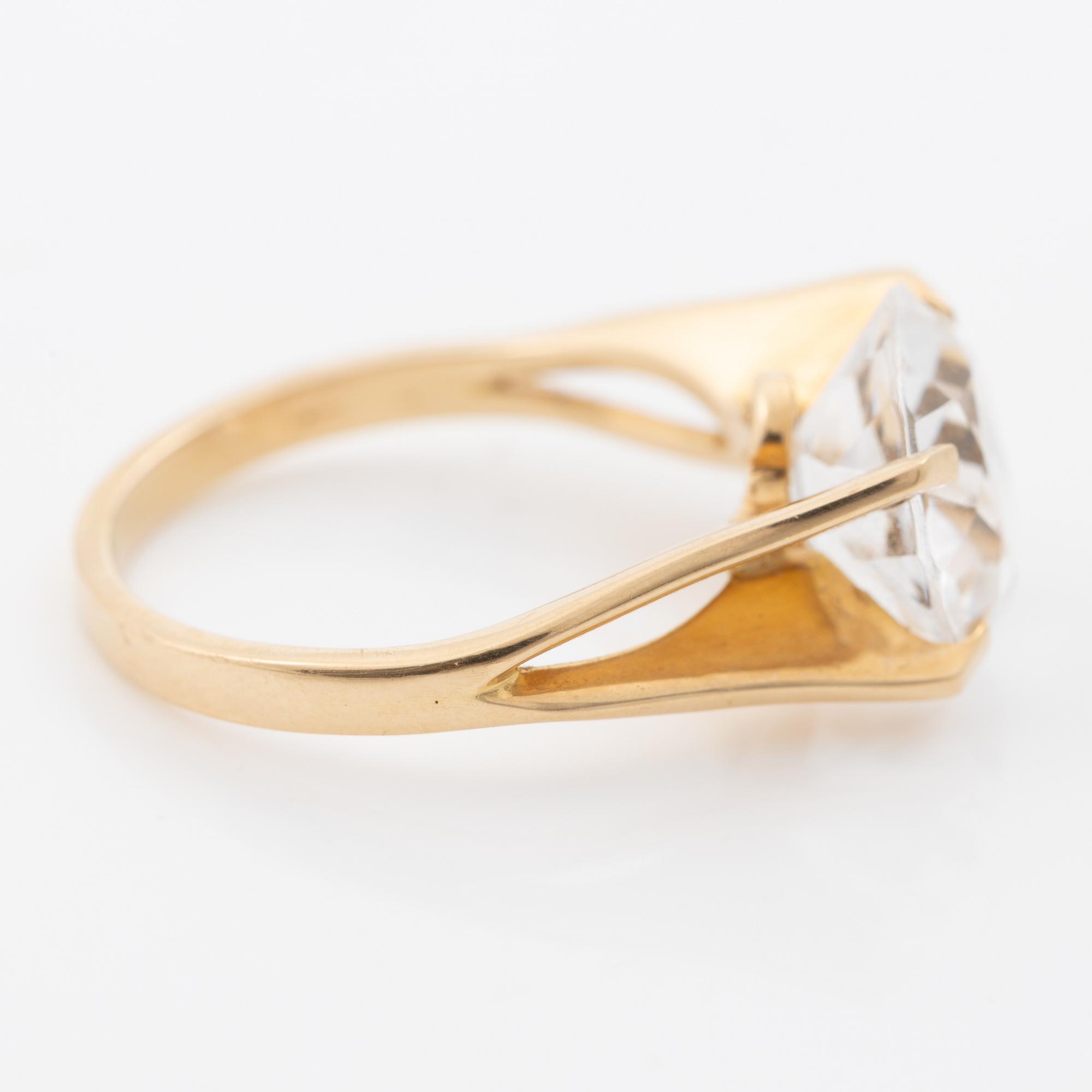 Ring, 18K gold with a synthetic white stone.