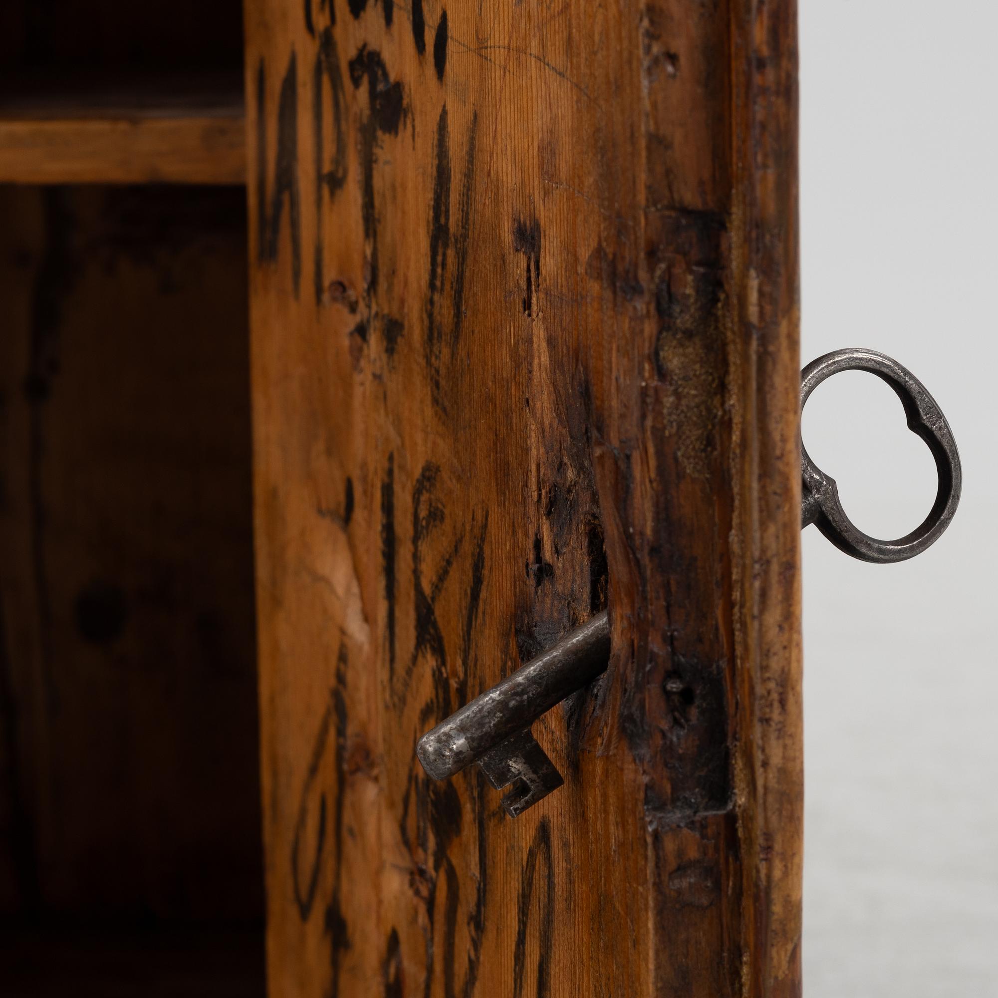A painted wall cabinet, dated 1817.