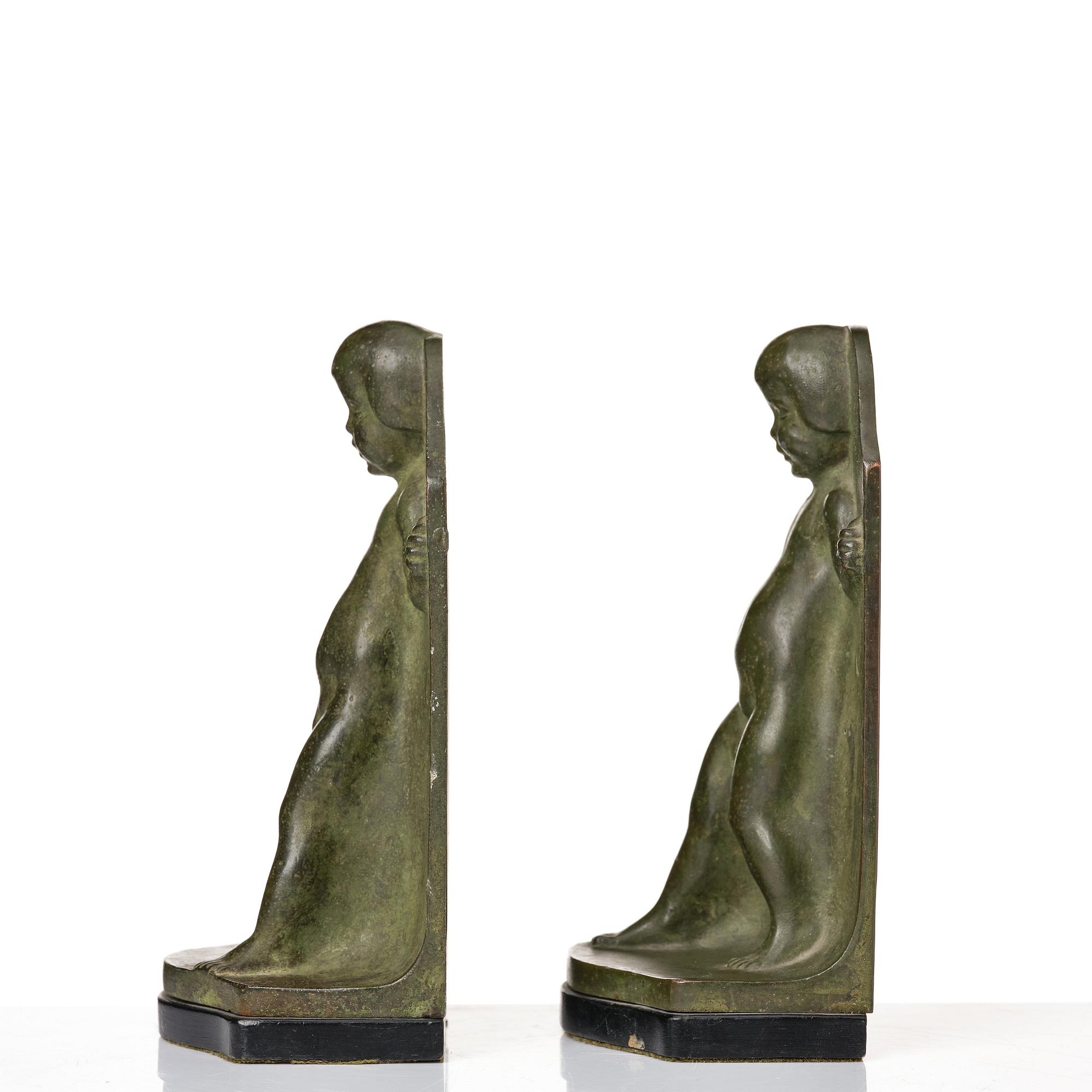 Axel Gute, a pair of green patinated metal bookends, Sweden, dated 1920.