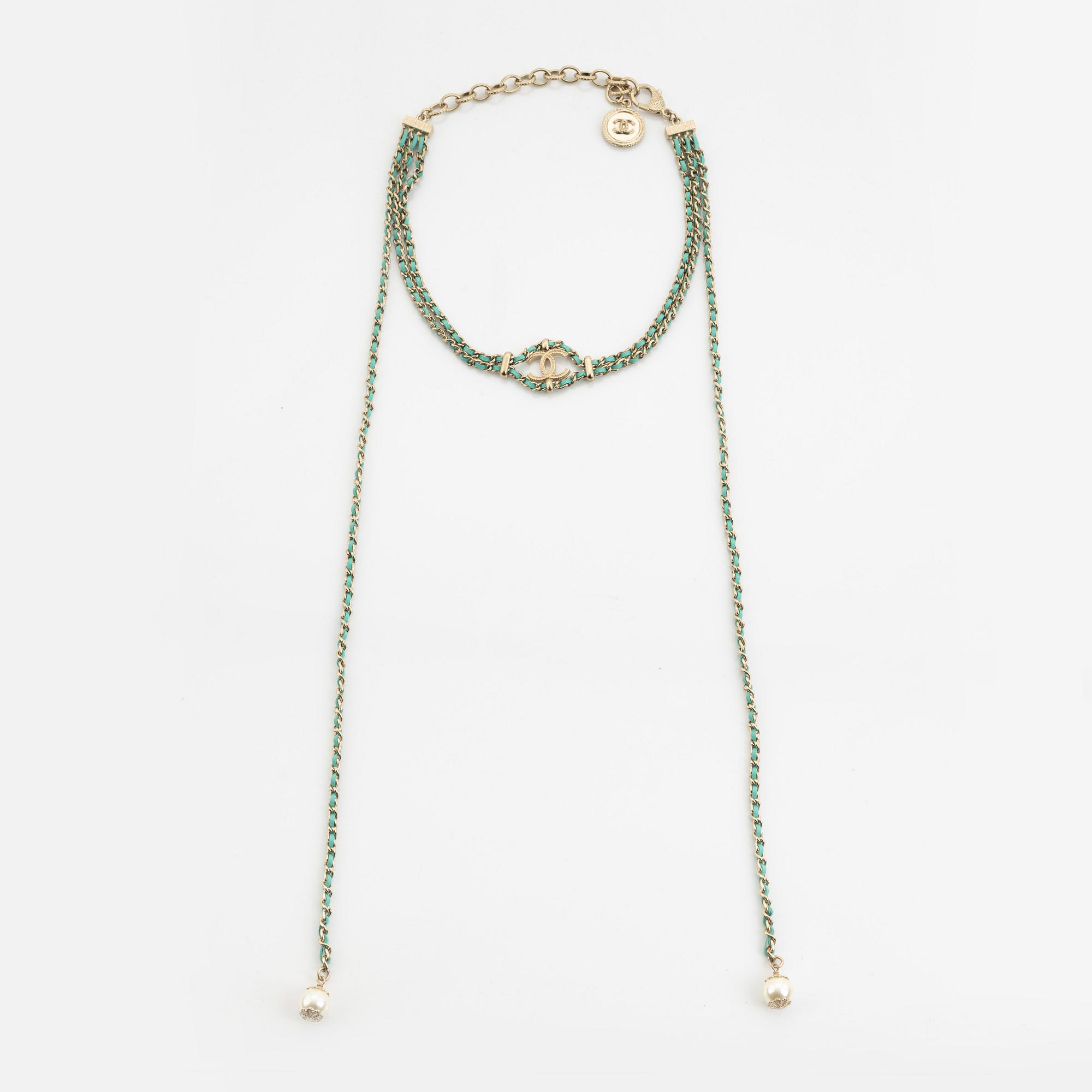 Chanel, a silver tone pearl and leather necklace.
